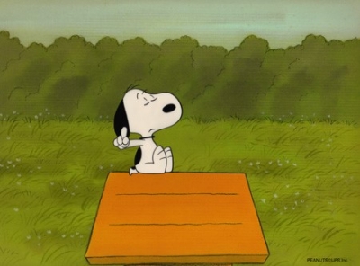 Snoopy sitting on his dog house