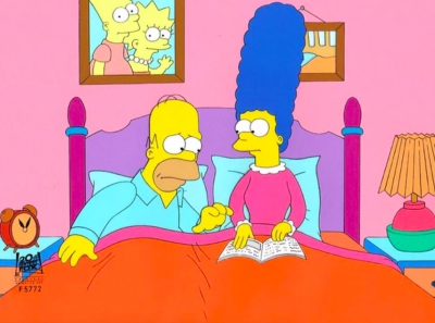 Homer Simpson and Marge Simpson in bed with photo of kids